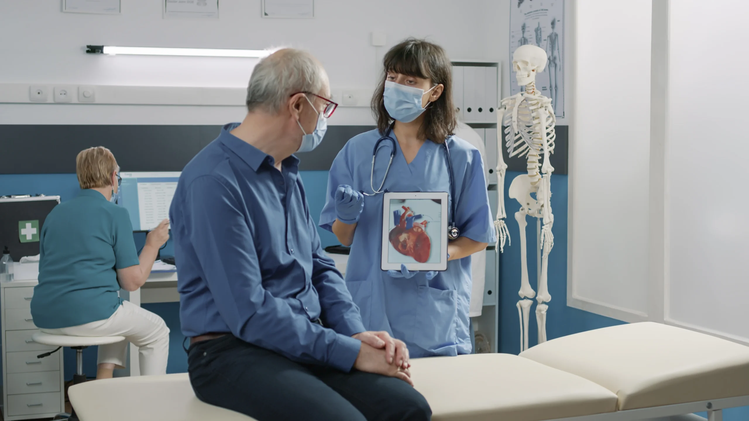 File name: female-assistant-holding-tablet-with-cardiovascular-system-illustration-explaining-heart-condition-retired-person-covid-19-pandemic-nurse-showing-cardiology-diagnosis-gadget-scaled